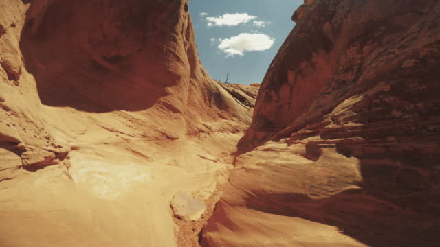 Summer travel in the Southwest USA: POV hiking in narrow canyon