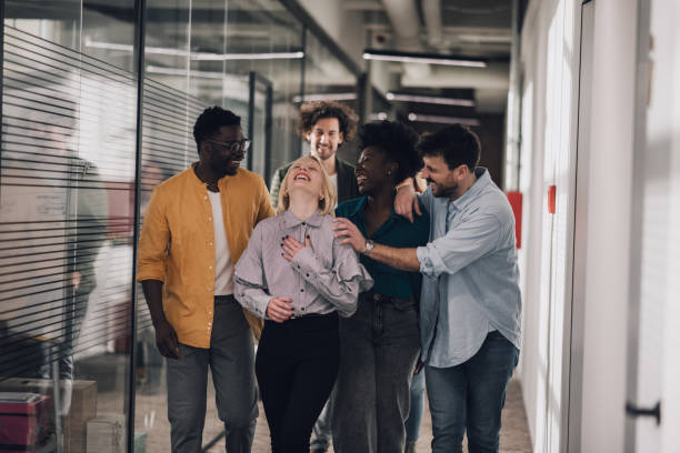 istock Enthusiastic group of startup employees having fun at the office 1386073247