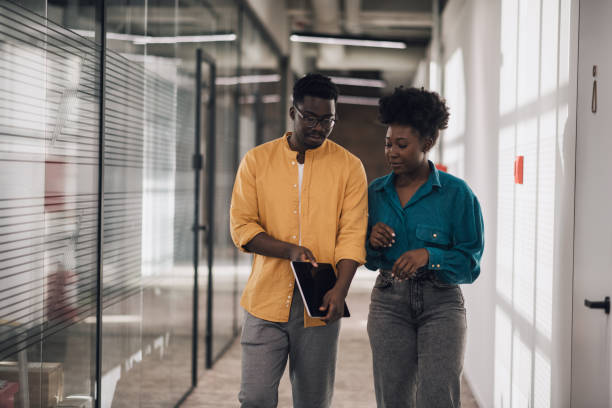 istock Two black startup employees walking together to get lunch 1386076341