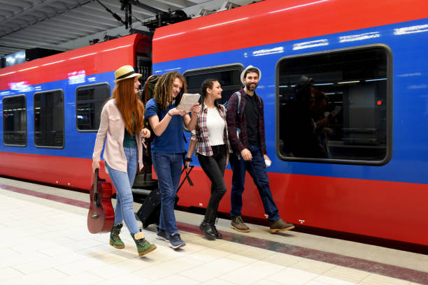 istock Few friends at the train station while waiting for a train for a long journey 1386078340