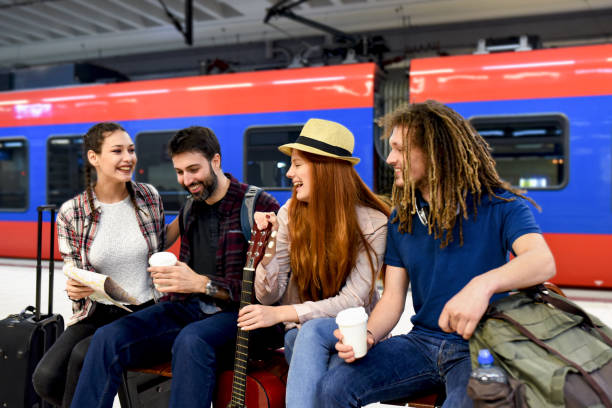 istock Few friends at the train station while waiting for a train for a long journey 1386078399