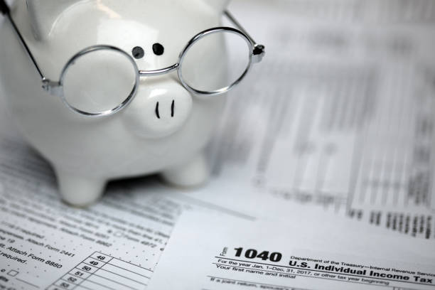 istock US Tax forms with piggybank 1386078925