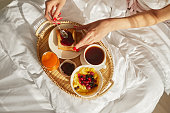 Woman hang breakfast on bed