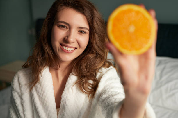 istock Woman showing orange at camera 1386079405