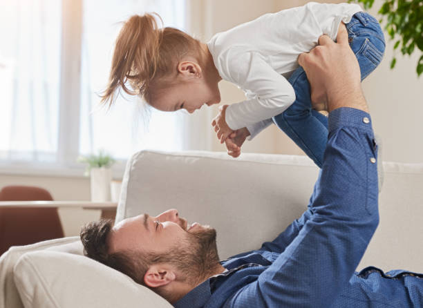 istock Father playing with daughter at home 1386079429