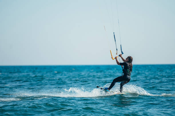 istock Woman kitesurfing on the ocean waters 1386079770