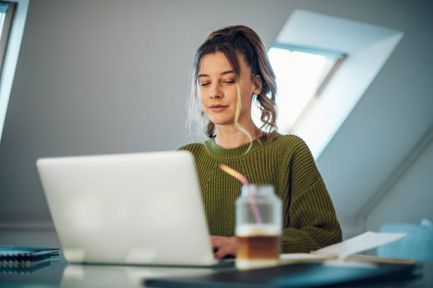 istock Woman working from a home on her a laptop 1386079783