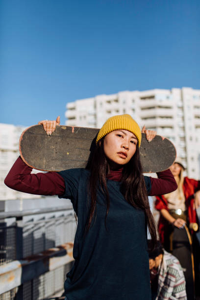 istock Young woman with skateboard 1386082749