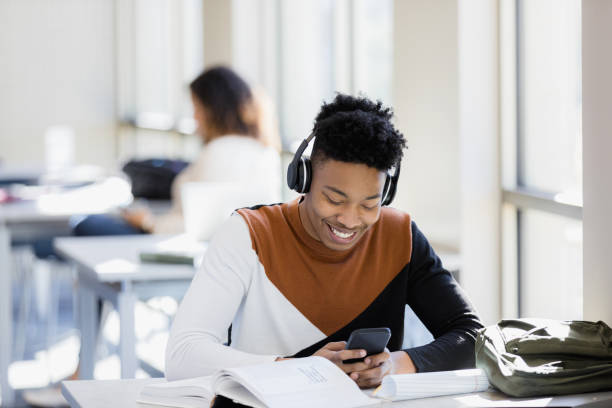 istock Teen boy gets distracted from homework by social media 1386085802