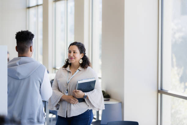istock Female librarian patiently listens to unrecognizable young man 1386085804