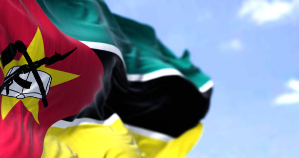 Detail of the national flag of Mozambique waving in the wind on a clear day Detail of the national flag of Mozambique waving in the wind on a clear day. Mozambique is a country located in Southeastern Africa. Selective focus. mozambique stock pictures, royalty-free photos & images