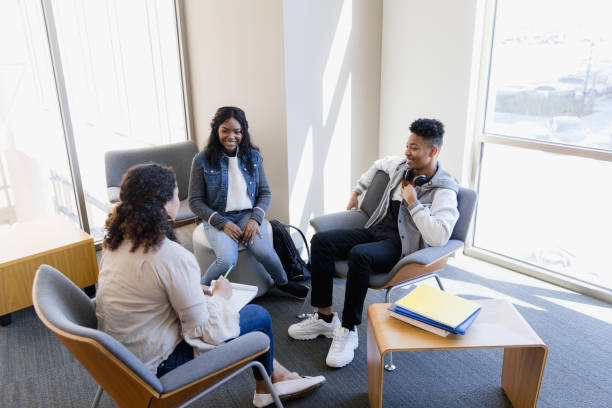 istock High angle view high school counselor meeting with students 1386085824
