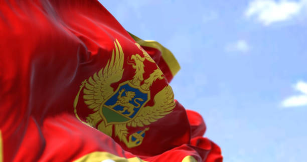 Detail of the national flag of Montenegro waving in the wind on a clear day. stock photo