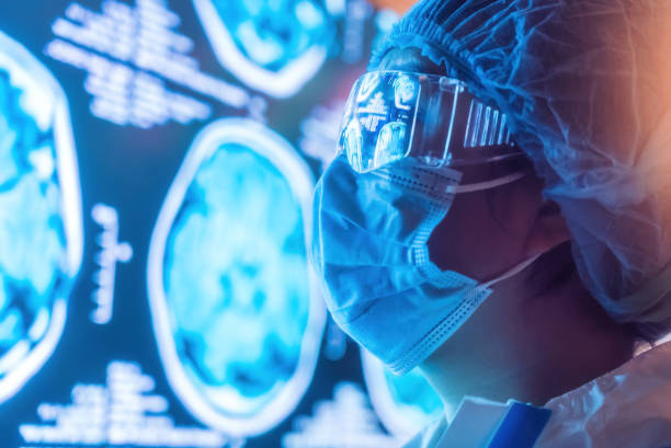 istock Medics wearing a protective suit and Looking CT examination image at Computer Monitor 1386091514