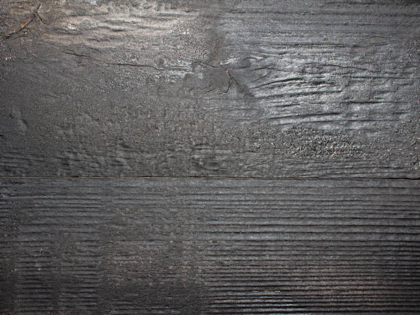 istock Texture photo of brushed burned wood plank. 1386092368