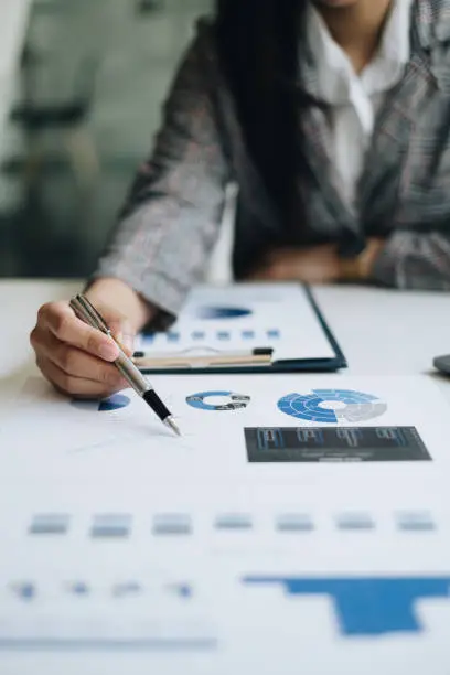 Photo of At Accounting office. Business woman calculating bills, tax and audit budget of company. statistics and credit analytic for mortgage payment concept.