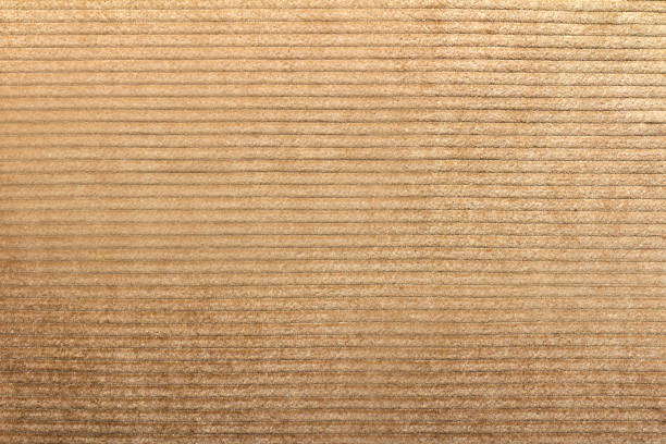 Beige colored corduroy cloth fabric texture. Texture backdrop photo of beige colored corduroy fabric cloth. corduroy jacket stock pictures, royalty-free photos & images