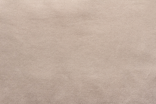 Texture backdrop photo of beige colored denim cloth.