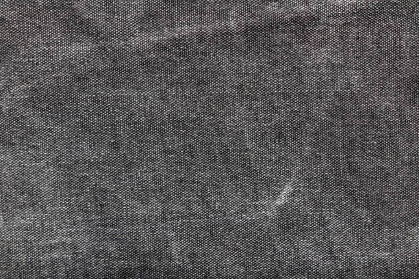 istock Texture backdrop photo of grey colored worn denim cloth. 1386094504