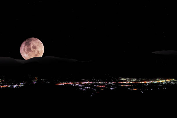istock Big full moon at city night 1386094793