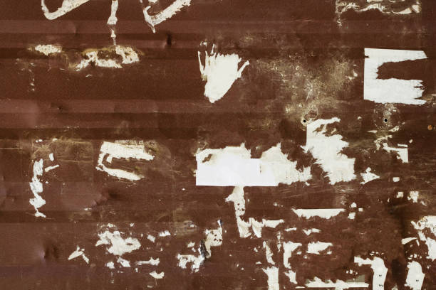 istock Grunge metal rusty wall with torn paper. 1386096833