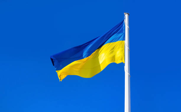 istock Ukrainian flag on blue sky. 1386097245