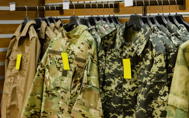 istock Tactical store racks with military clothing. 1386097325