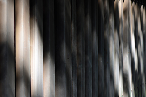 Side view of wooden fence with Sunlight and shadow.