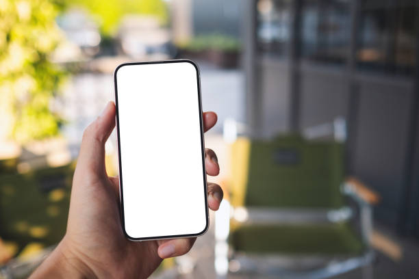 istock Mockup image of a man holding mobile phone with blank white screen in cafe 1386105352
