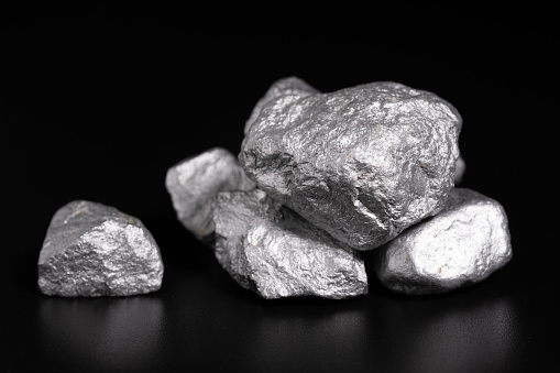 lump of silver or platinum or rare earth minerals on black background