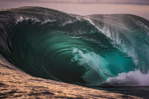 istock Large green wave crashing into ocean 1386136869