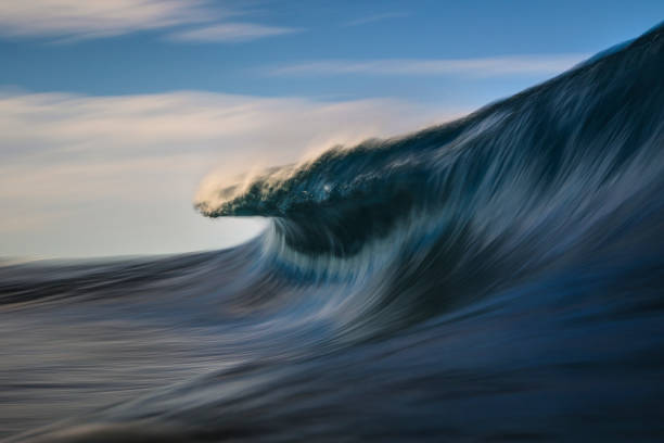 istock Long exposure of blue wave moving out at sea 1386137399