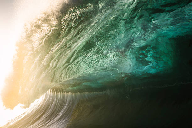 istock Beautiful teal green ocean wave in golden light 1386137493
