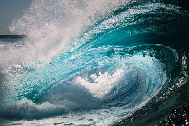 istock Powerful bright blue ocean wave crashing into sea 1386137909
