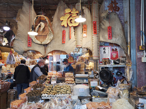 People shopping at local dried food shop in Kowloon City, Kowloon peninsula, Hong Kong.