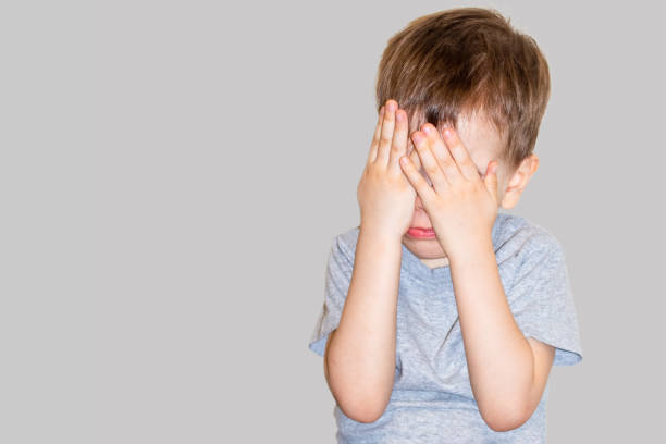 istock The boy covered his face with his hands 1386148943