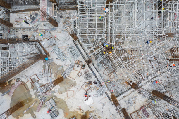 istock Overhead shot of steel bars and busy construction workers at construction site 1386148977