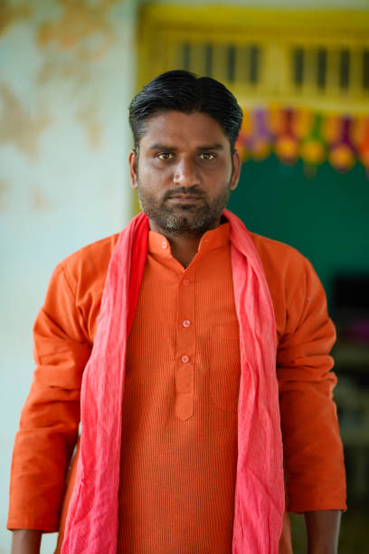 Young indian farmer in traditional wear and giving expression. stock photo