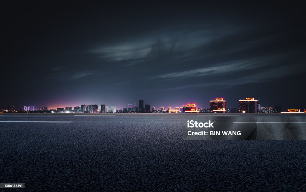 The night view of the city in front of the asphalt road City Stock Photo