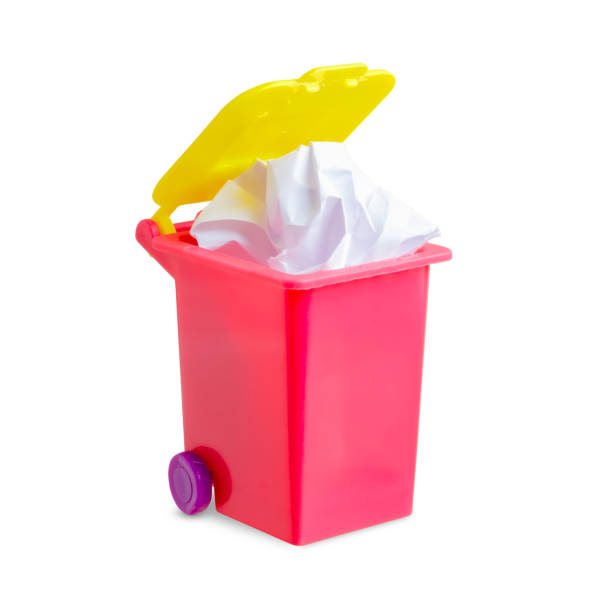 istock Waste paper in a dumpster. The concept of garbage separation. Isolated on white. 1386156148