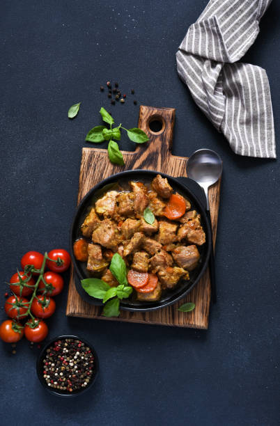 istock Stew with spices, tomatoes and carrots on a concrete cheno background. 1386158222
