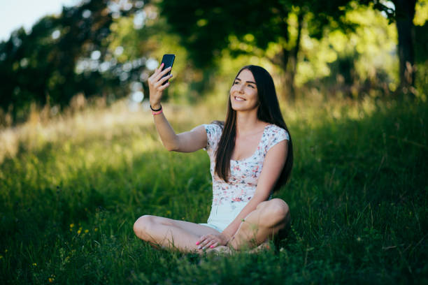 istock Girl taking selfie in the park 1386161391