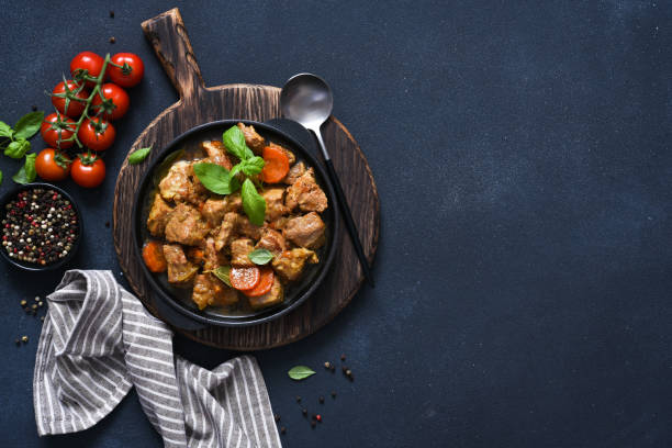 istock Stew with spices, tomatoes and carrots on a concrete cheno background. 1386161444