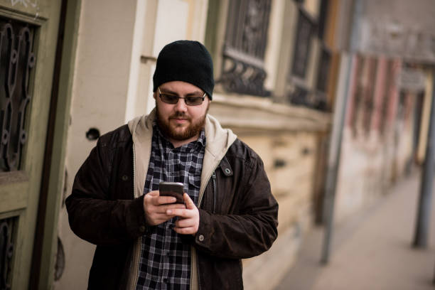 istock Man using phone in the city 1386161505