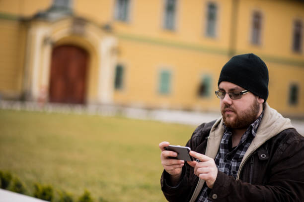 istock Man using phone in the city 1386161509