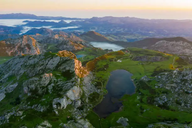 Serene landscape with one of Lakes of Covadonga and mountain range at dusk
