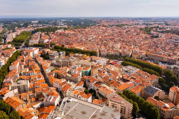 Bird's eye view of Perpignan, France. Red rooftops of residential buildings visible from above.