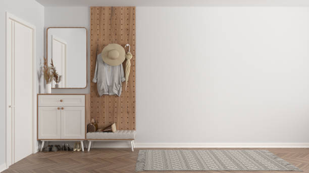istock Modern scandinavian lobby, minimalist white hall with stucco walls, empty space with cabinet, mirror, bench, wooden coat hanger, shoes, clothes, umbrella. Copy space interior design 1386164704