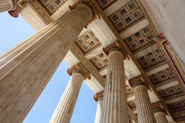 Athens Academy entrance ceiling under view. Greece. Classic column upper part and gold ornate roof, elegant neoclassicel building