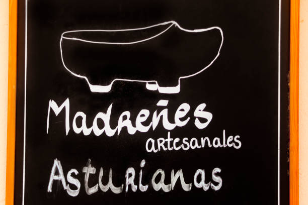 Traditional craft wooden clogs advertisement on a blackboard, seen in the street. Oviedo, Asturias, Spain.